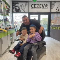 Copii fericiți în scaunul de barber — salon modern Cezeva, familie